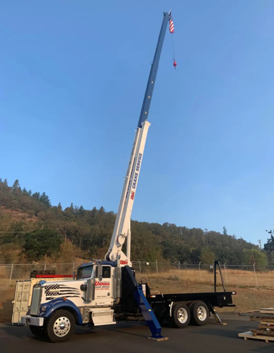 Umpqua Sheet Metal crane truck with fully extended boom ready for heavy lifting operations